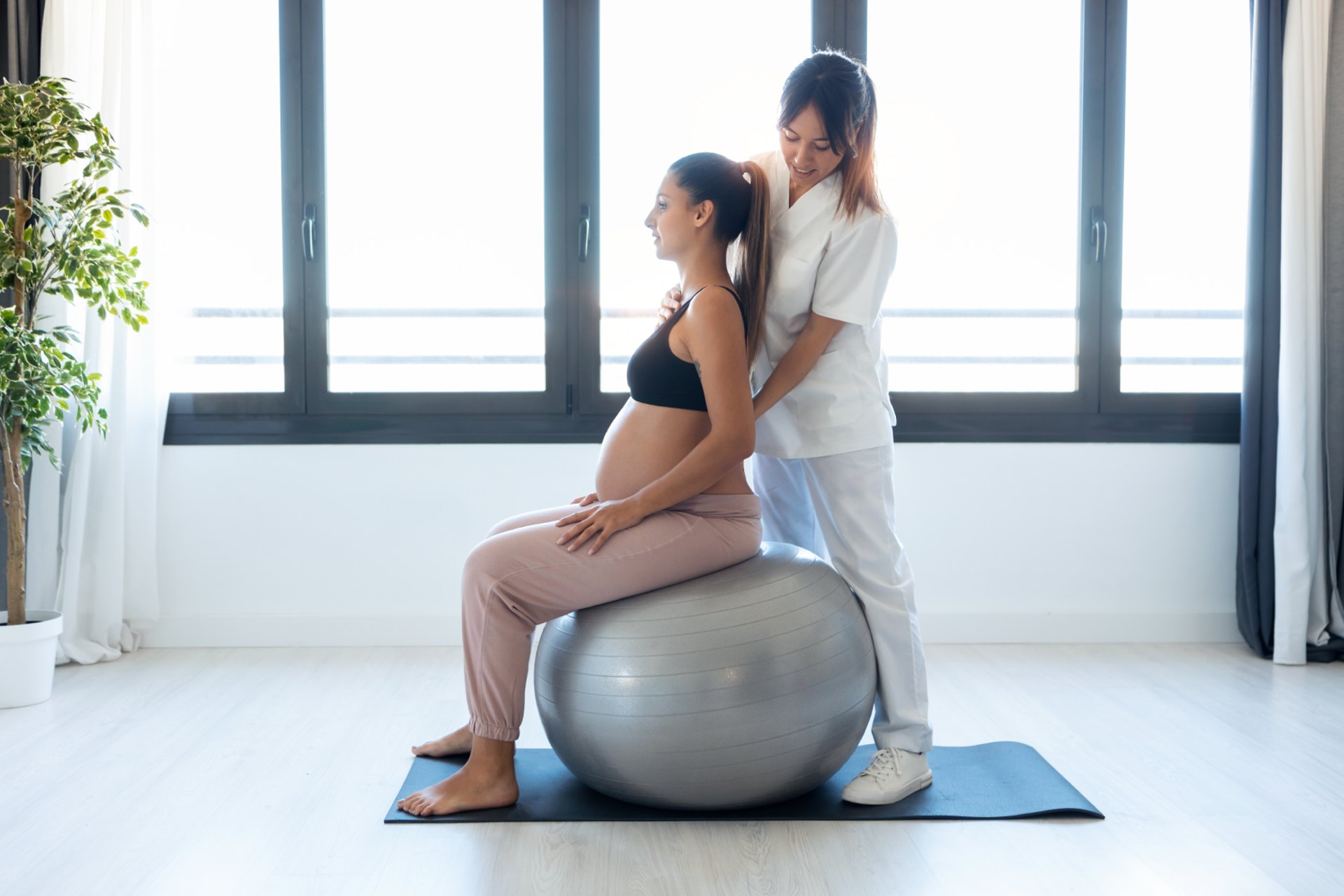 Doctor providing pre- and postnatal care guidance to pregnant woman