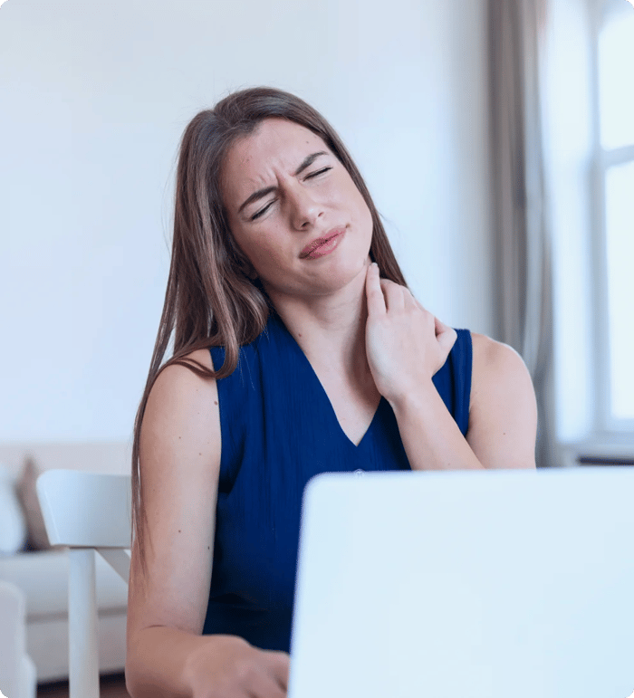 Woman rubbing her neck with her right hand due to pain
